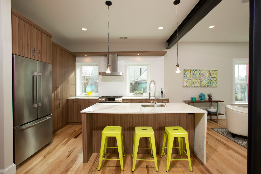 Mid-sized trendy l-shaped medium tone wood floor eat-in kitchen photo in DC Metro with an undermount sink, flat-panel cabinets, medium tone wood cabinets, white backsplash, ceramic backsplash, stainless steel appliances, an island and marble countertops