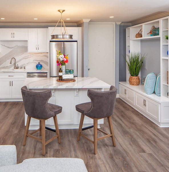 Mid-sized transitional l-shaped vinyl floor and gray floor eat-in kitchen photo in San Diego with an undermount sink, shaker cabinets, white cabinets, quartzite countertops, white backsplash, stone slab backsplash, stainless steel appliances, an island and white countertops