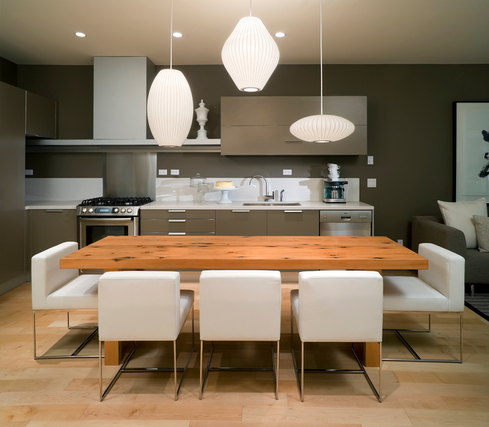 This is an example of a contemporary l-shaped open plan kitchen in Vancouver with flat-panel cabinets, grey cabinets, white splashback and stainless steel appliances.