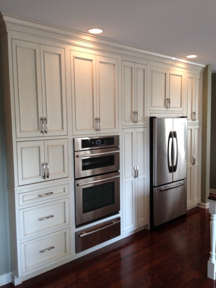 Example of a classic single-wall eat-in kitchen design in Other with beaded inset cabinets, white cabinets and stainless steel appliances