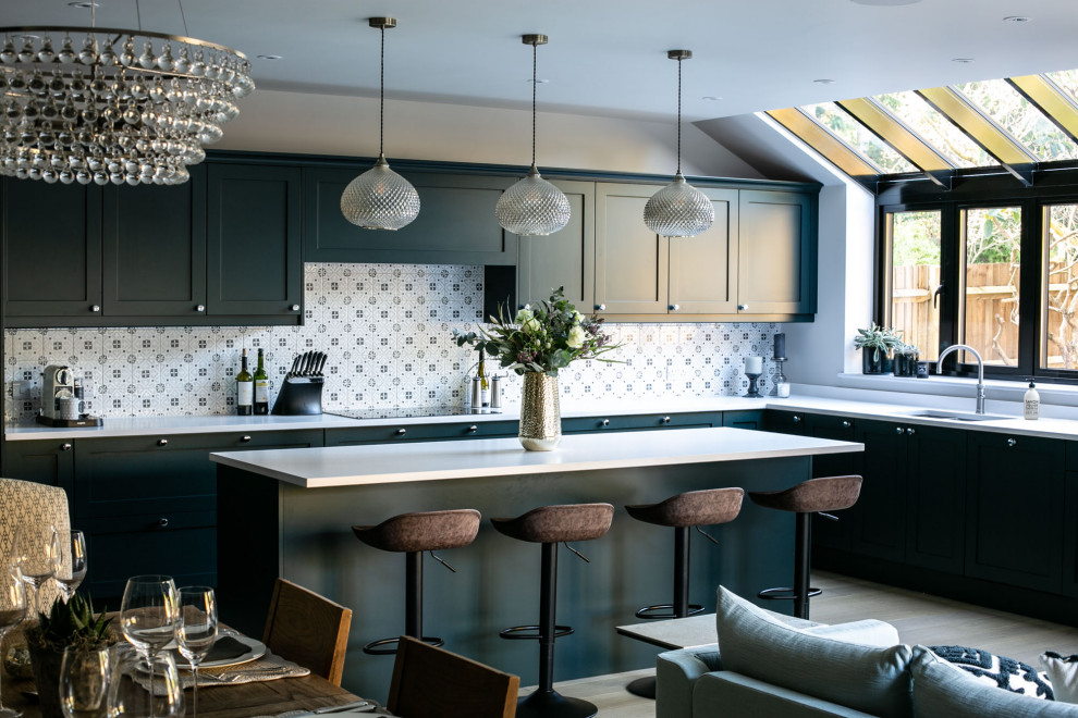 Esempio di una cucina chic con lavello sottopiano, ante in stile shaker, ante grigie, paraspruzzi bianco, parquet chiaro, pavimento beige e top bianco