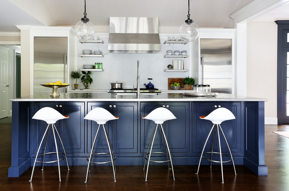 Kitchen - transitional galley dark wood floor kitchen idea in New York with an island, white backsplash and stainless steel appliances