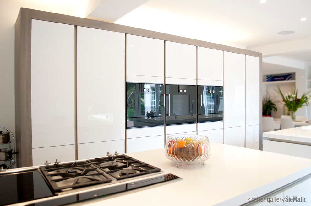This is an example of an expansive contemporary open plan kitchen in West Midlands with multiple islands.