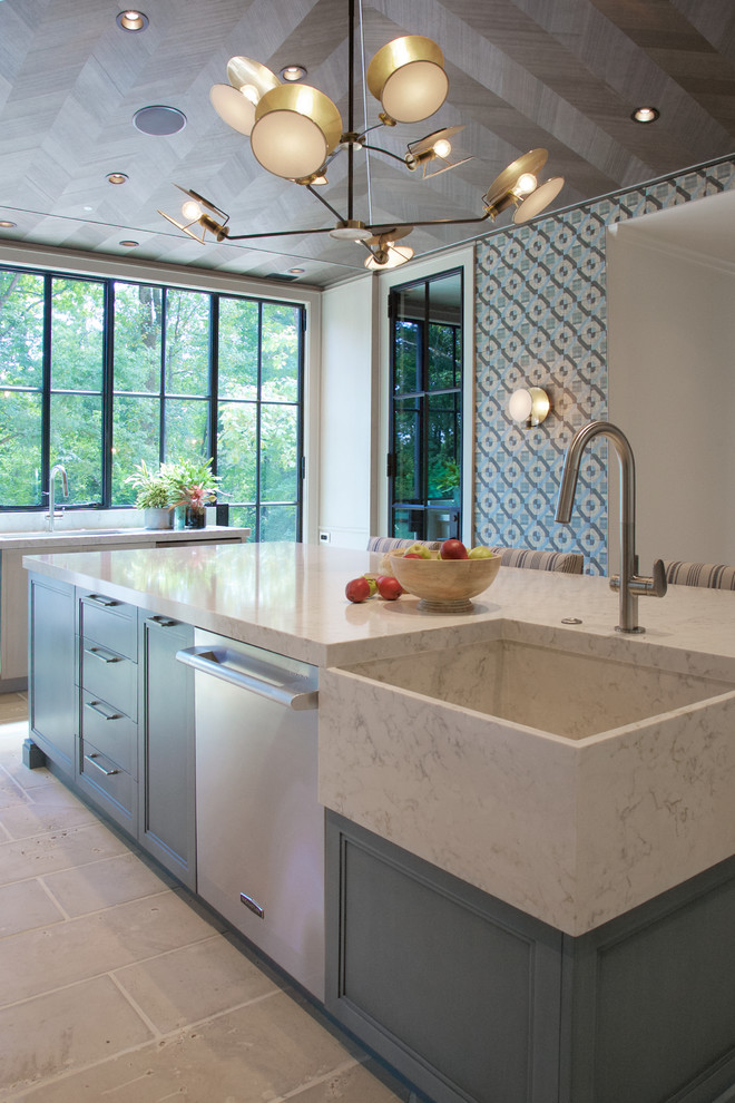 Inspiration for an expansive farmhouse enclosed kitchen in Atlanta with a belfast sink, recessed-panel cabinets, blue cabinets, engineered stone countertops, stainless steel appliances, concrete flooring, an island, beige floors and white worktops.