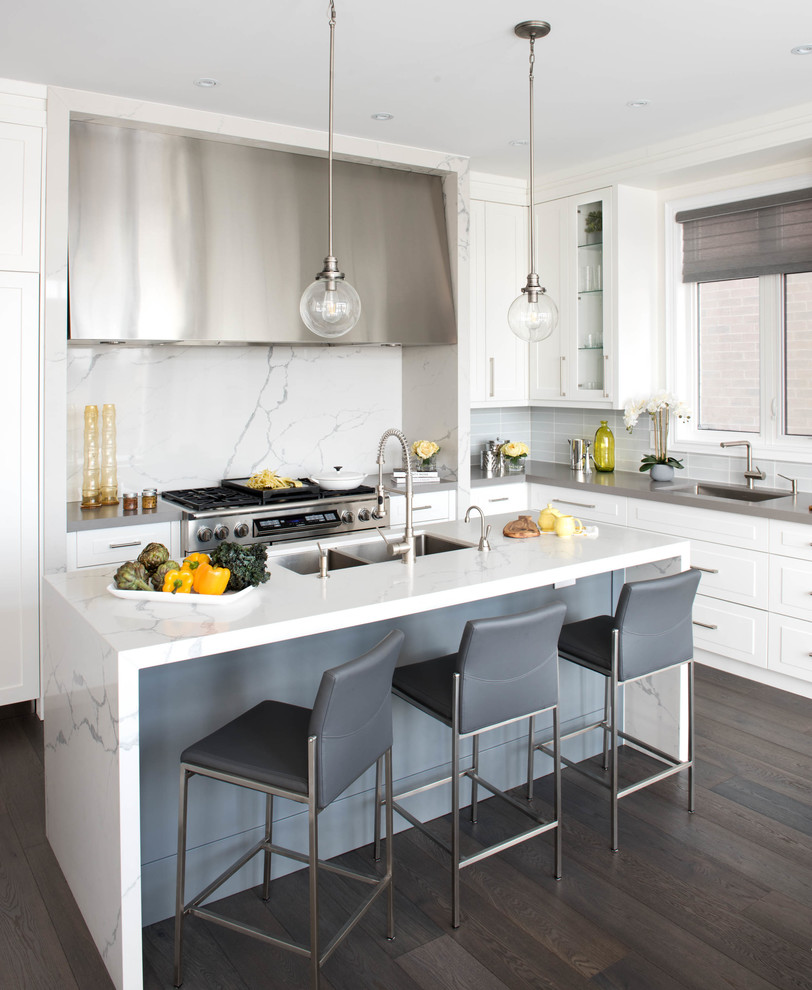Design ideas for a medium sized classic l-shaped kitchen in Toronto with a submerged sink, raised-panel cabinets, white cabinets, stainless steel appliances, dark hardwood flooring, an island, brown floors and grey worktops.