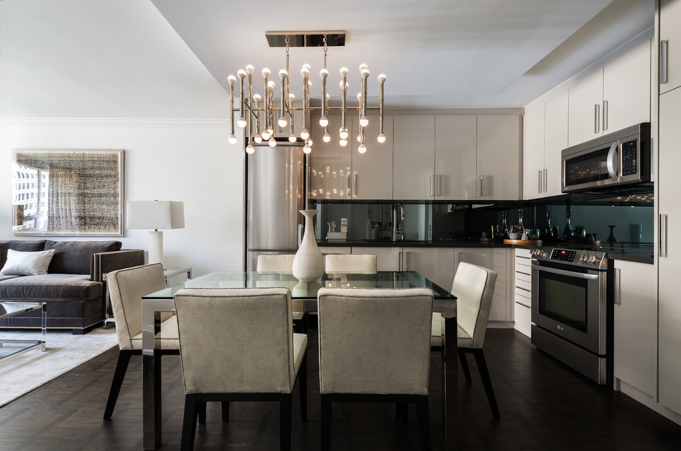 Inspiration for a small contemporary l-shaped dark wood floor and brown floor open concept kitchen remodel in Toronto with an undermount sink, flat-panel cabinets, gray cabinets, quartz countertops, stainless steel appliances, no island and black backsplash