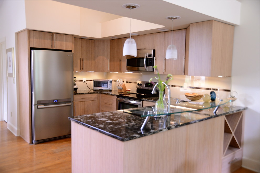 Example of a small trendy u-shaped light wood floor eat-in kitchen design in New York with flat-panel cabinets, light wood cabinets, granite countertops, white backsplash, stainless steel appliances, subway tile backsplash, an undermount sink and no island