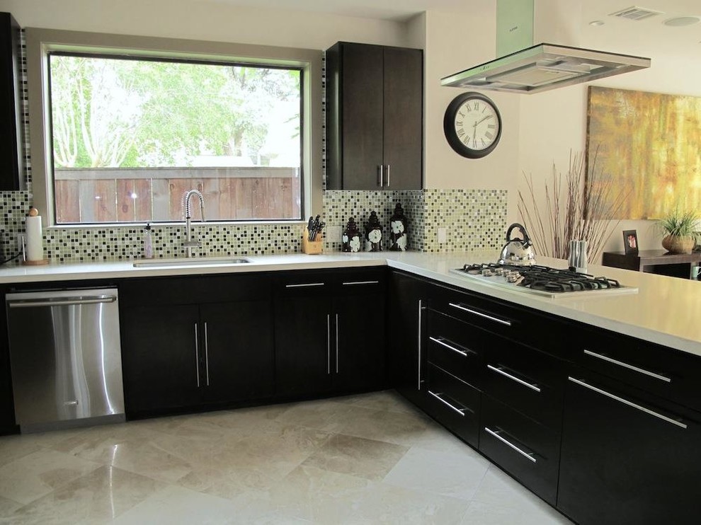 Large minimalist u-shaped travertine floor kitchen photo in New York with an undermount sink, flat-panel cabinets, black cabinets, solid surface countertops, multicolored backsplash, mosaic tile backsplash, stainless steel appliances and an island