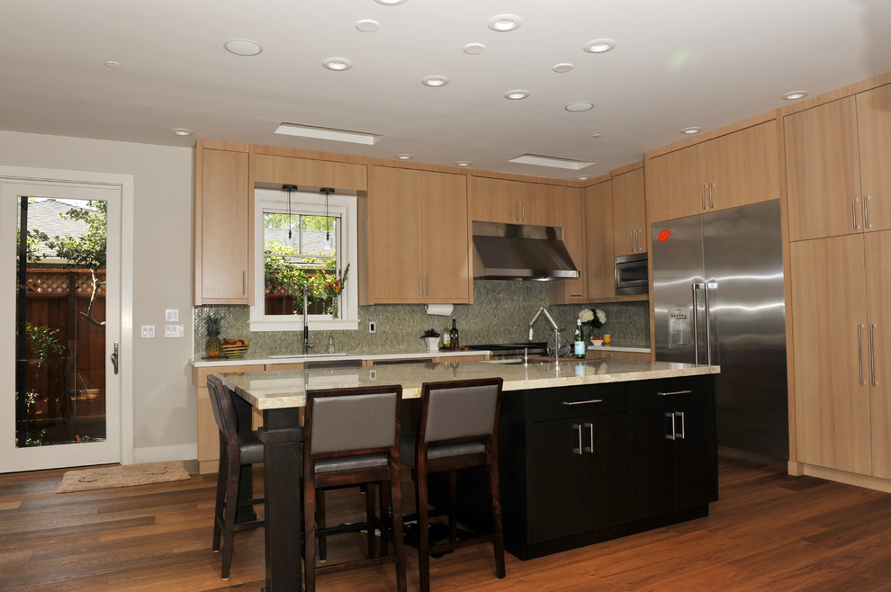 Eat-in kitchen - mid-sized contemporary l-shaped medium tone wood floor eat-in kitchen idea in San Francisco with an undermount sink, flat-panel cabinets, light wood cabinets, stainless steel appliances, an island, multicolored backsplash, glass tile backsplash and quartzite countertops