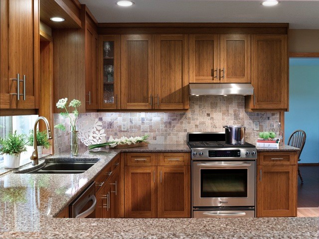 Classic u-shaped kitchen in Portland with shaker cabinets and medium wood cabinets.