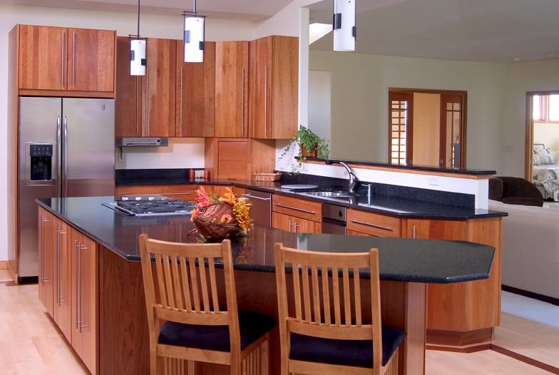 Immagine di una cucina contemporanea con lavello sottopiano, ante lisce, ante in legno scuro, top in granito, paraspruzzi nero, paraspruzzi con piastrelle di vetro e elettrodomestici in acciaio inossidabile
