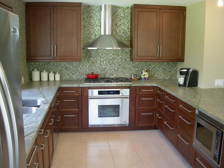 Mid-sized trendy u-shaped ceramic tile eat-in kitchen photo in San Diego with a double-bowl sink, recessed-panel cabinets, medium tone wood cabinets, green backsplash, mosaic tile backsplash, stainless steel appliances, a peninsula and granite countertops