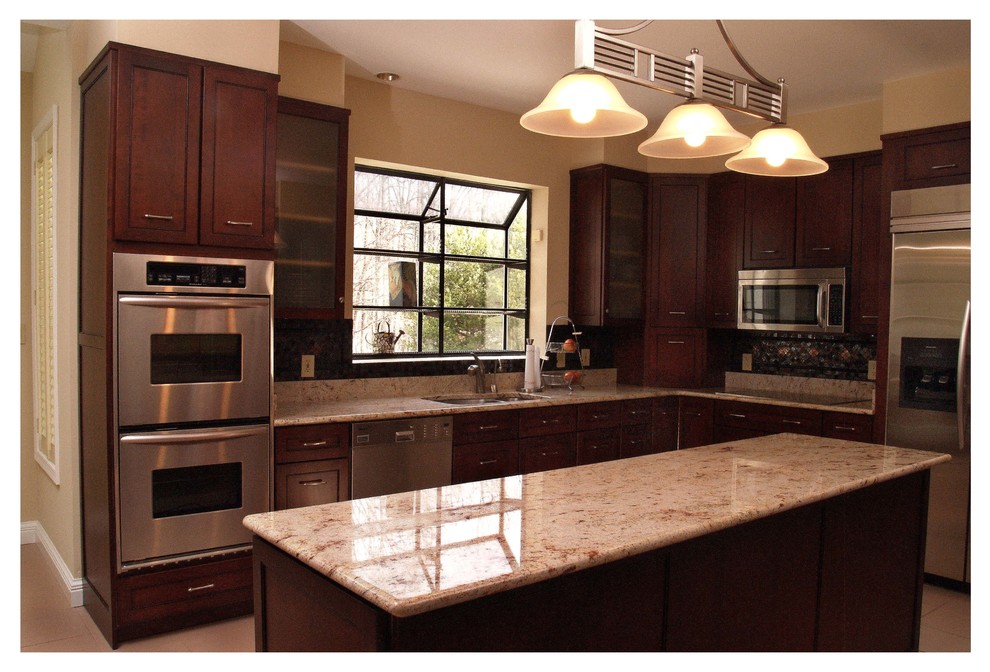 Mid-sized arts and crafts l-shaped ceramic tile enclosed kitchen photo in Baltimore with shaker cabinets, an island, an undermount sink, dark wood cabinets, granite countertops, multicolored backsplash, stainless steel appliances and mosaic tile backsplash