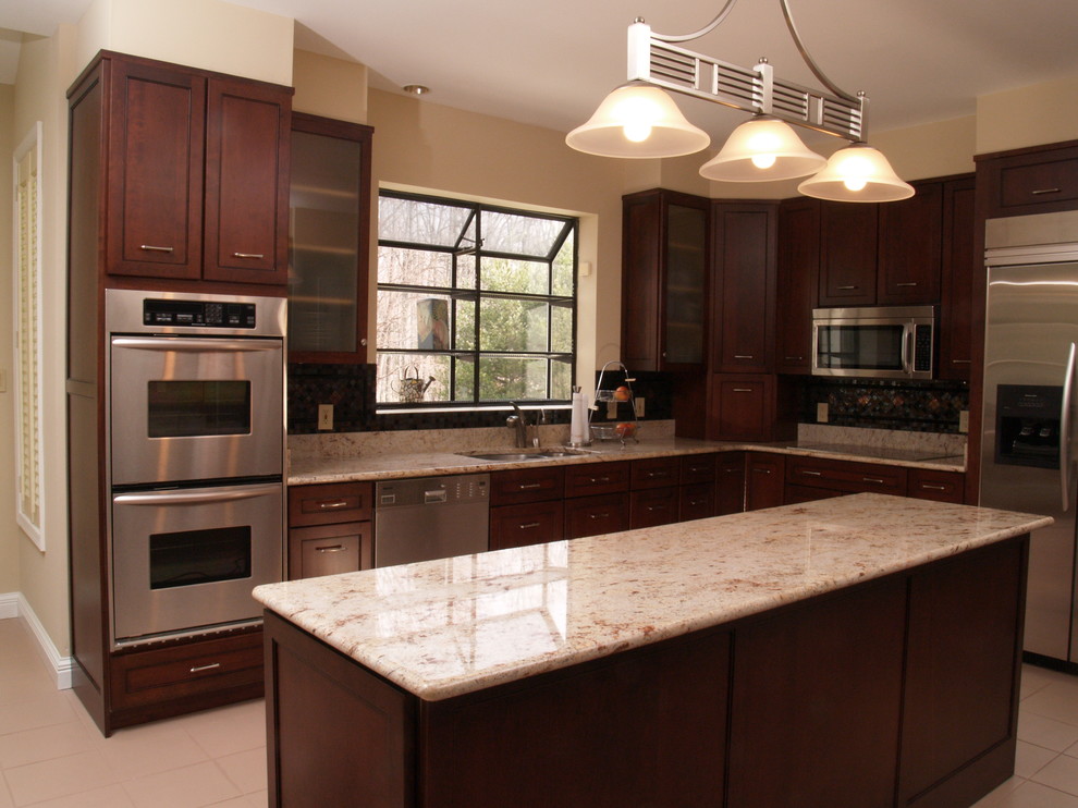 Mid-sized trendy l-shaped ceramic tile enclosed kitchen photo in Baltimore with an undermount sink, dark wood cabinets, granite countertops, stainless steel appliances, an island, shaker cabinets, multicolored backsplash and mosaic tile backsplash