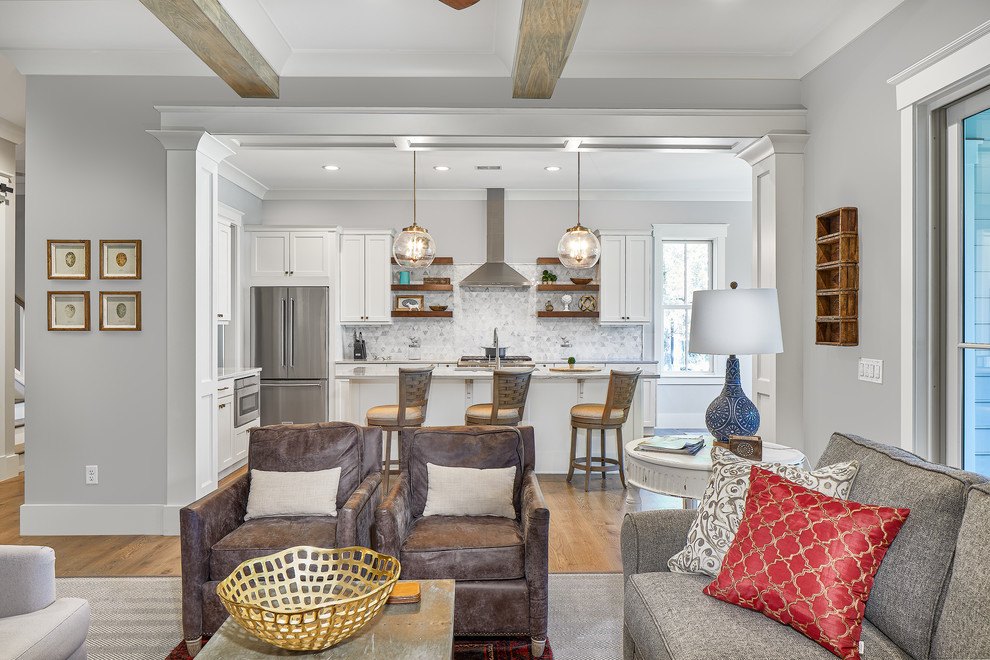 Inspiration for a large coastal u-shaped brown floor and medium tone wood floor open concept kitchen remodel in Charleston with a drop-in sink, white backsplash, mosaic tile backsplash, stainless steel appliances, an island, white countertops and white cabinets