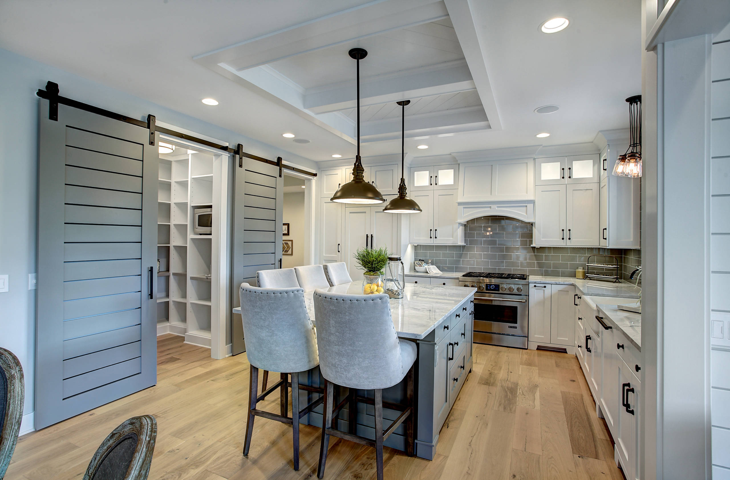 White Kitchen Cabinets With Steel Appliances And Light Tone Hardwood Floor  Stock Photo, Picture and Royalty Free Image. Image 60405349.