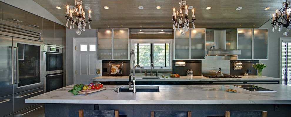 Huge trendy u-shaped eat-in kitchen photo in New York with an undermount sink, marble countertops, gray backsplash, paneled appliances and an island