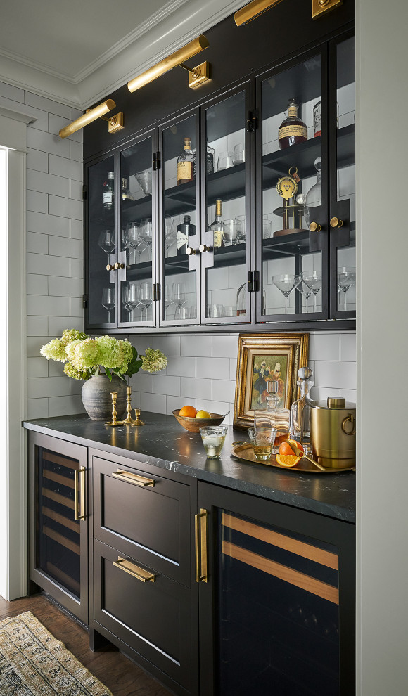 Mid-sized transitional medium tone wood floor kitchen pantry photo in Chicago with a farmhouse sink, shaker cabinets, quartzite countertops, white backsplash, subway tile backsplash, paneled appliances, an island, black countertops and black cabinets