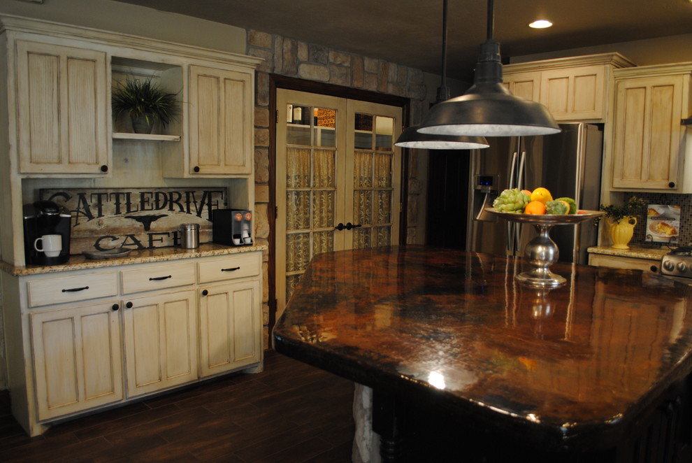 Example of a large country l-shaped dark wood floor and brown floor eat-in kitchen design in Oklahoma City with a farmhouse sink, recessed-panel cabinets, white cabinets, granite countertops, gray backsplash, mosaic tile backsplash, stainless steel appliances and an island
