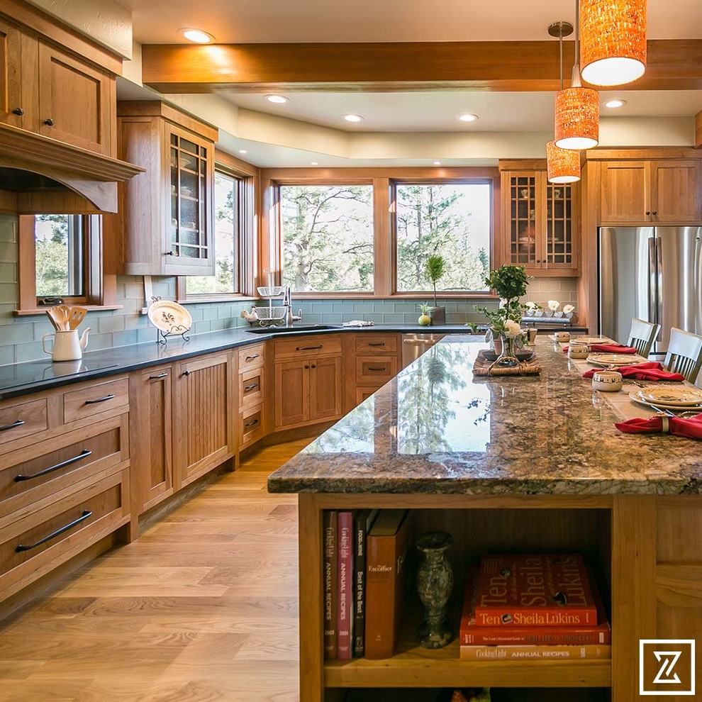 Inspiration for a large craftsman l-shaped light wood floor open concept kitchen remodel in Other with an undermount sink, shaker cabinets, light wood cabinets, granite countertops, green backsplash, ceramic backsplash, stainless steel appliances and an island