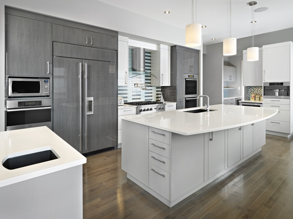 Photo of a contemporary grey and white kitchen in Edmonton with integrated appliances.