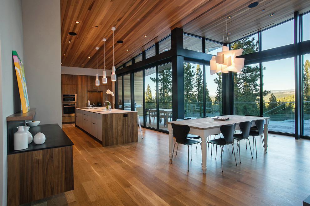 Inspiration for a large contemporary l-shaped medium tone wood floor eat-in kitchen remodel in Sacramento with an undermount sink, flat-panel cabinets, medium tone wood cabinets, stainless steel appliances and an island