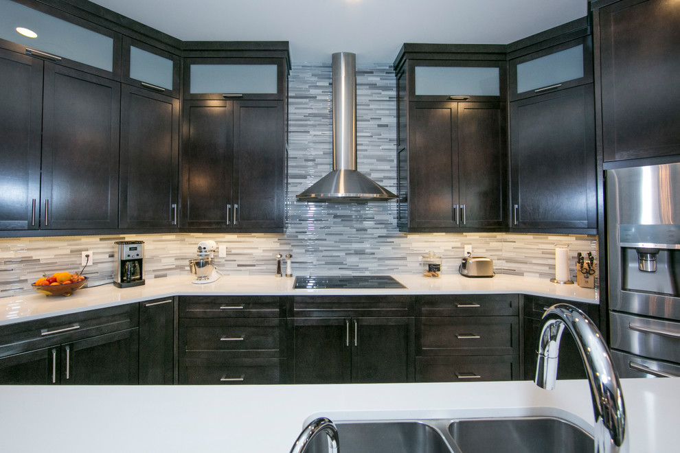 Example of a large trendy single-wall ceramic tile open concept kitchen design in Edmonton with a double-bowl sink, recessed-panel cabinets, dark wood cabinets, multicolored backsplash, matchstick tile backsplash, stainless steel appliances and an island