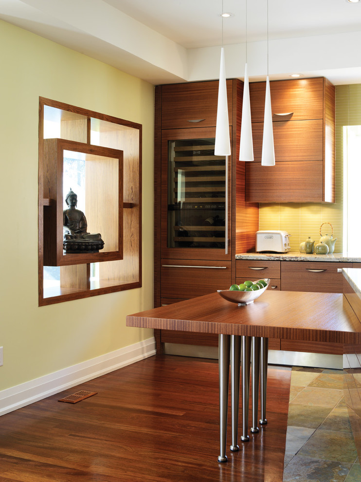 Photo of a large world-inspired l-shaped kitchen/diner in Dallas with a submerged sink, flat-panel cabinets, light wood cabinets, granite worktops, metallic splashback, metal splashback, stainless steel appliances, light hardwood flooring and an island.