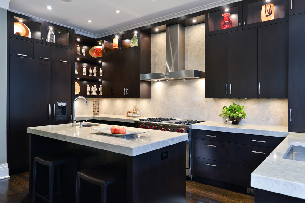 Contemporary u-shaped kitchen in Chicago with a submerged sink, flat-panel cabinets, dark wood cabinets, white splashback and stainless steel appliances.