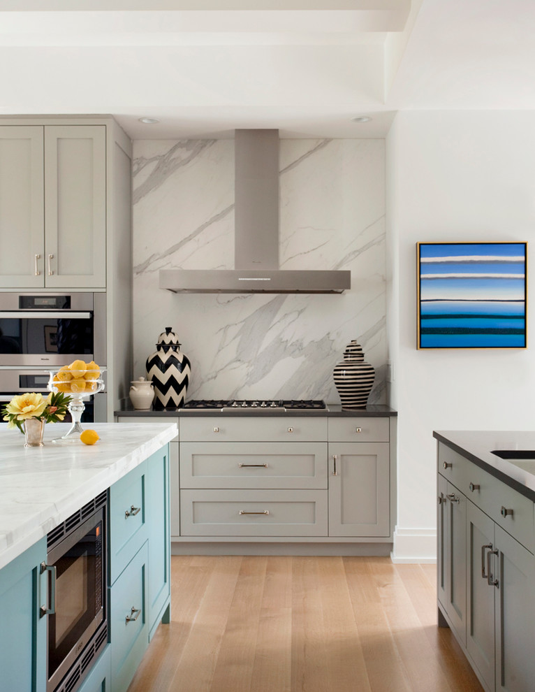 Design ideas for a classic kitchen in Boston with a submerged sink, shaker cabinets, grey cabinets, white splashback, stainless steel appliances, light hardwood flooring and marble splashback.