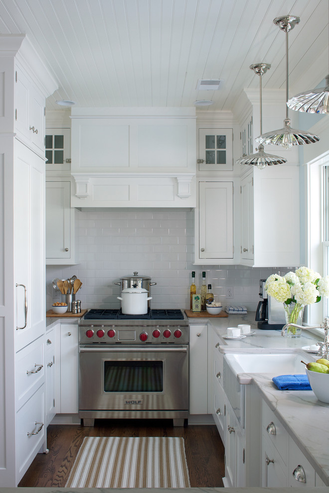 Example of a small country u-shaped enclosed kitchen design in Other with white cabinets, quartzite countertops, white backsplash, subway tile backsplash, stainless steel appliances and a farmhouse sink