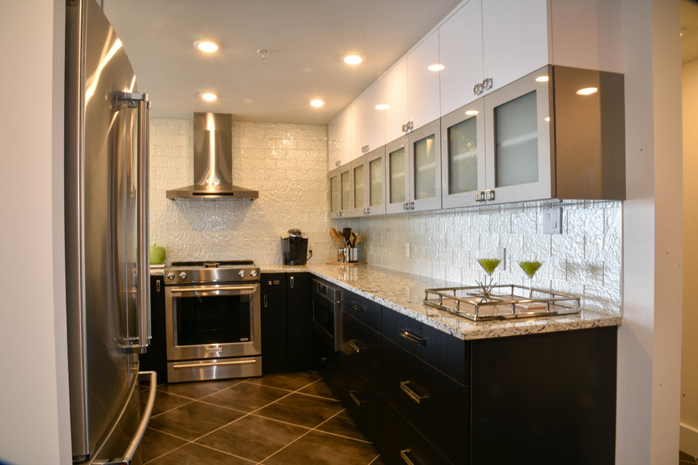 Example of a small trendy u-shaped ceramic tile enclosed kitchen design in Tampa with flat-panel cabinets, quartz countertops, stainless steel appliances and no island