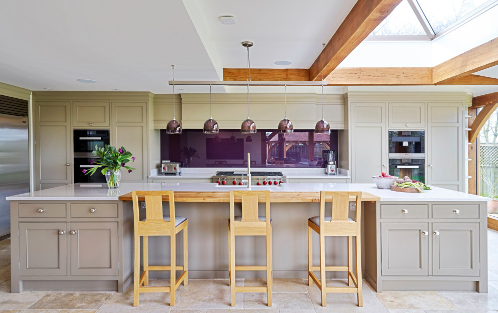Immagine di una grande cucina minimal con lavello stile country, ante a filo, ante grigie, paraspruzzi con lastra di vetro, elettrodomestici in acciaio inossidabile e top bianco