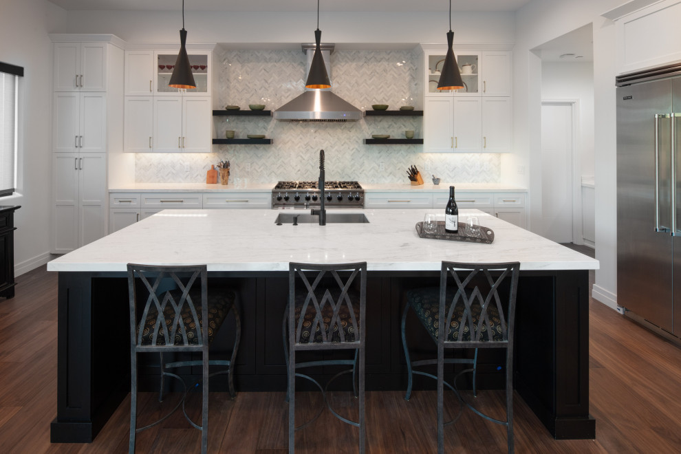 Inspiration for a large transitional l-shaped dark wood floor and brown floor open concept kitchen remodel in San Luis Obispo with a single-bowl sink, shaker cabinets, black cabinets, marble countertops, white backsplash, marble backsplash, stainless steel appliances, an island and white countertops
