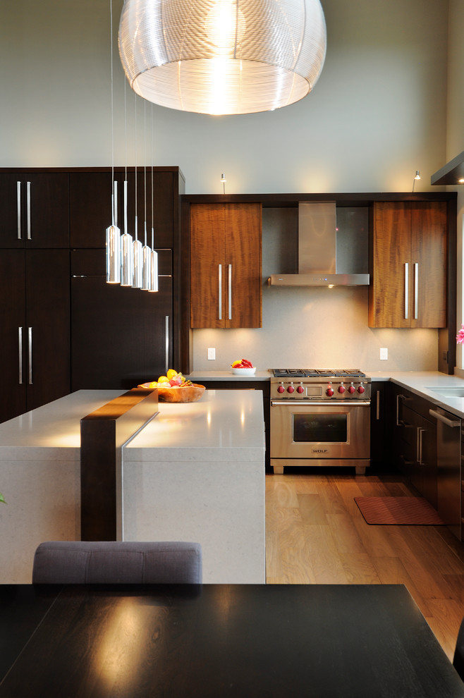 Huge trendy l-shaped eat-in kitchen photo in Toronto with an undermount sink, flat-panel cabinets, dark wood cabinets, quartz countertops and paneled appliances