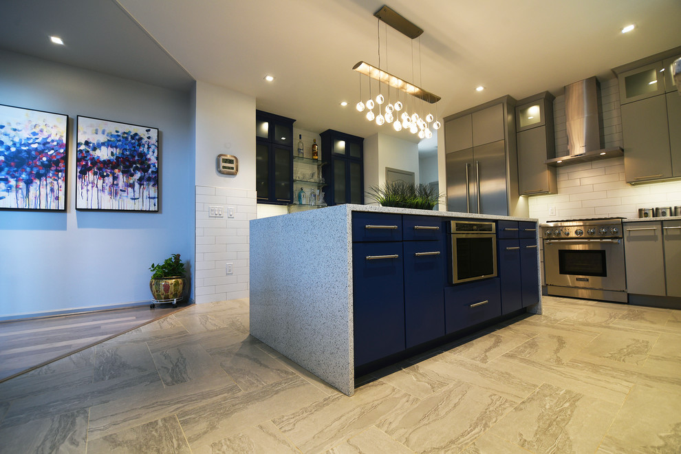 Large trendy l-shaped porcelain tile eat-in kitchen photo in Baltimore with a farmhouse sink, flat-panel cabinets, gray cabinets, quartz countertops, white backsplash, ceramic backsplash, stainless steel appliances and an island