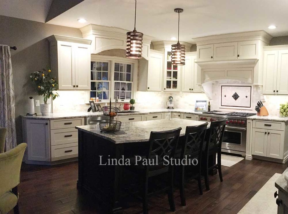 Trendy u-shaped dark wood floor eat-in kitchen photo in Denver with recessed-panel cabinets, white cabinets, granite countertops, beige backsplash, stone tile backsplash, stainless steel appliances and an island