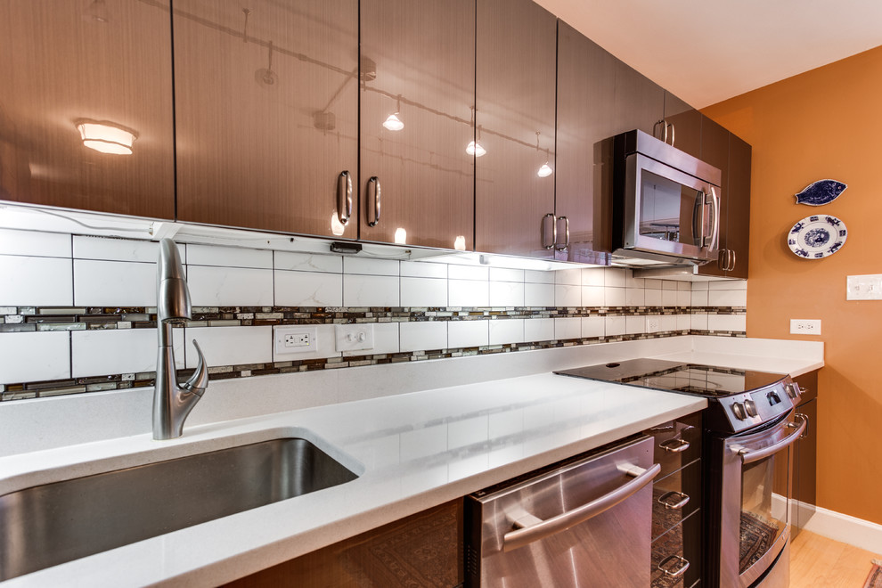 Photo of a medium sized contemporary l-shaped kitchen in DC Metro with a submerged sink, engineered stone countertops, stainless steel appliances, medium hardwood flooring and an island.
