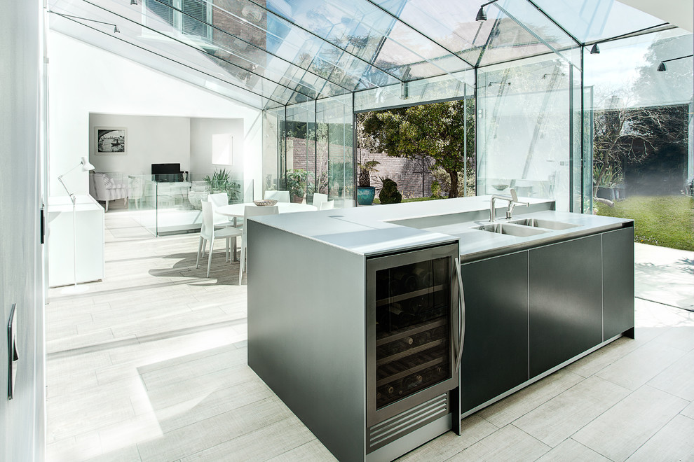 Contemporary open plan kitchen in Other with an integrated sink, flat-panel cabinets and black cabinets.