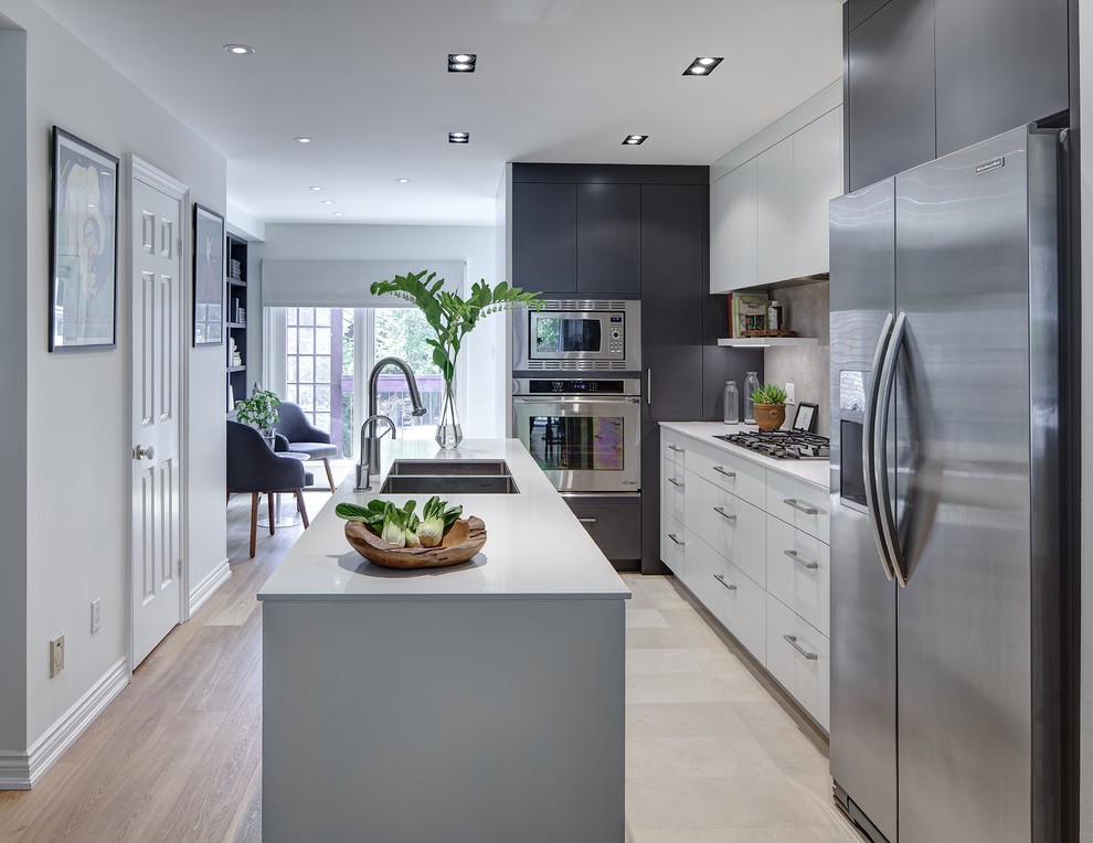 Eat-in kitchen - small contemporary galley travertine floor eat-in kitchen idea in Toronto with a double-bowl sink, flat-panel cabinets, gray cabinets, quartz countertops, gray backsplash, porcelain backsplash, stainless steel appliances and an island