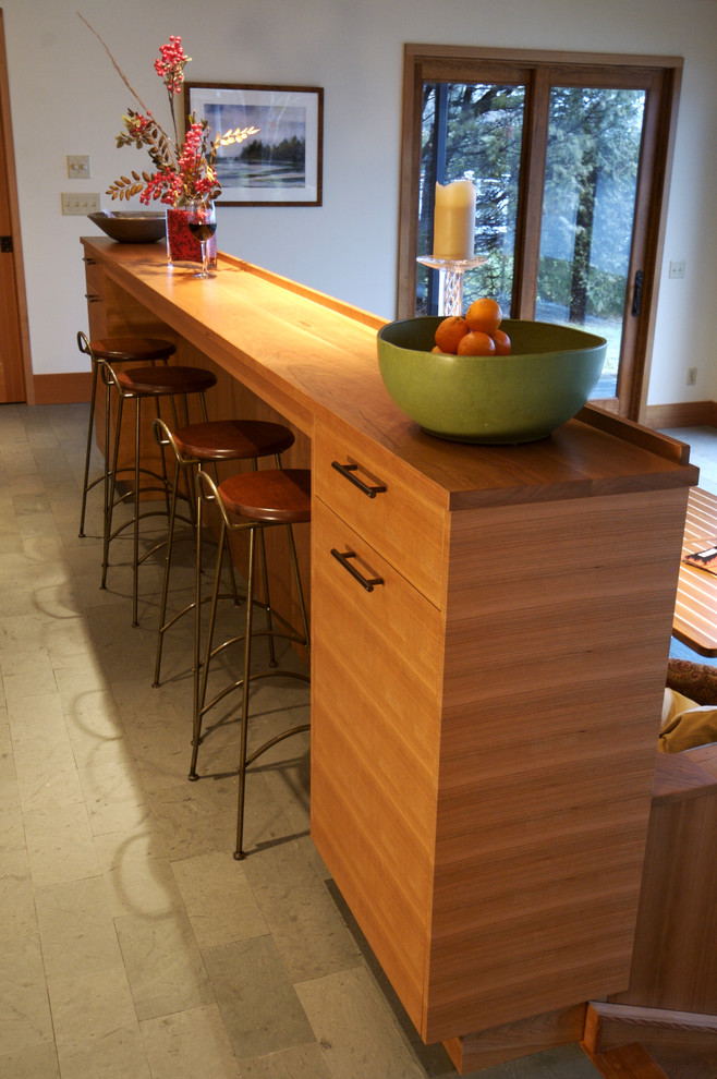 This is an example of a contemporary kitchen in Burlington with medium wood cabinets and wood worktops.