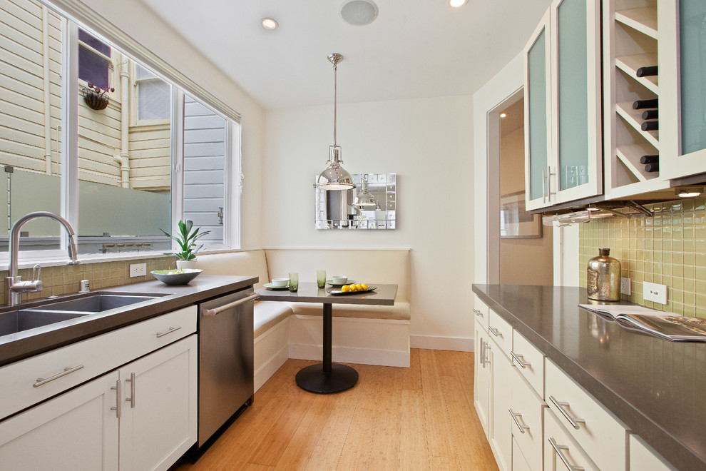 This is an example of a contemporary kitchen/diner in San Francisco with a double-bowl sink, white cabinets and beige splashback.