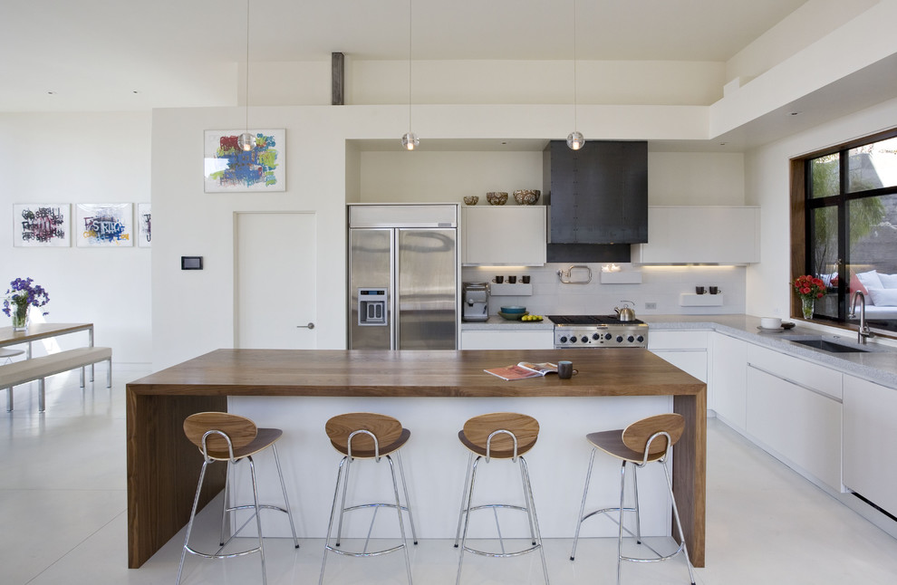 Eat-in kitchen - contemporary l-shaped eat-in kitchen idea in San Francisco with an undermount sink, flat-panel cabinets, white cabinets, white backsplash, cement tile backsplash, stainless steel appliances and concrete countertops