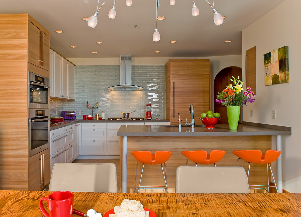 Eat-in kitchen - contemporary l-shaped eat-in kitchen idea in Boston with paneled appliances, an undermount sink, shaker cabinets, white cabinets, quartz countertops, blue backsplash and glass tile backsplash