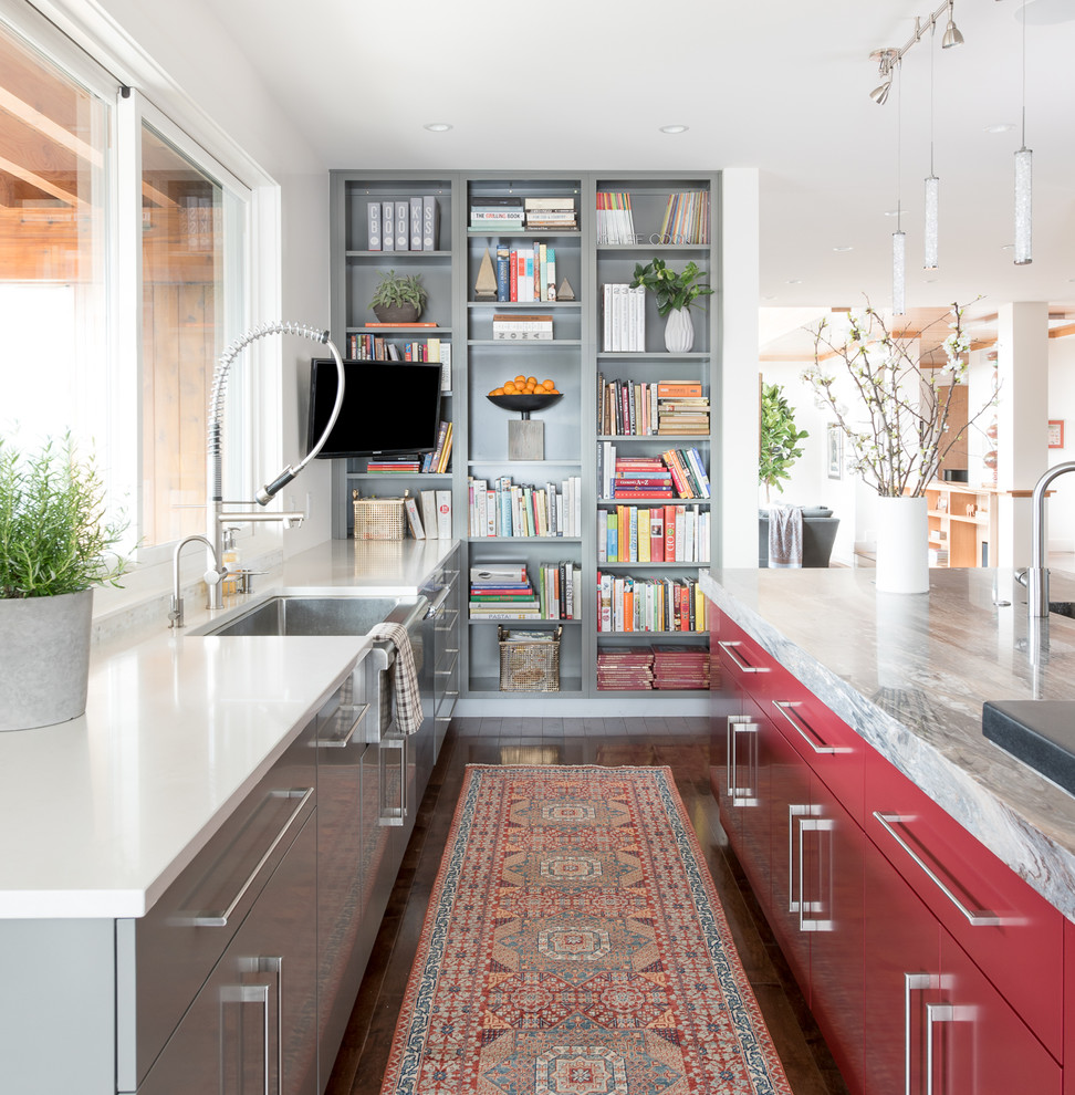 Trendy dark wood floor and brown floor kitchen photo in Denver with a farmhouse sink, flat-panel cabinets, red cabinets and an island