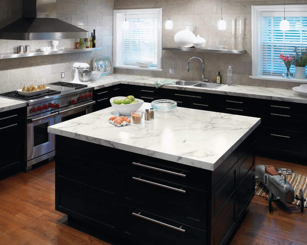 Trendy kitchen photo in Cincinnati with a drop-in sink, stainless steel appliances, black cabinets and laminate countertops