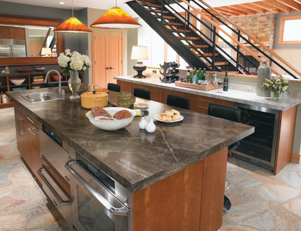 Photo of a contemporary kitchen in Cincinnati with stainless steel appliances, a built-in sink, flat-panel cabinets, medium wood cabinets and laminate countertops.