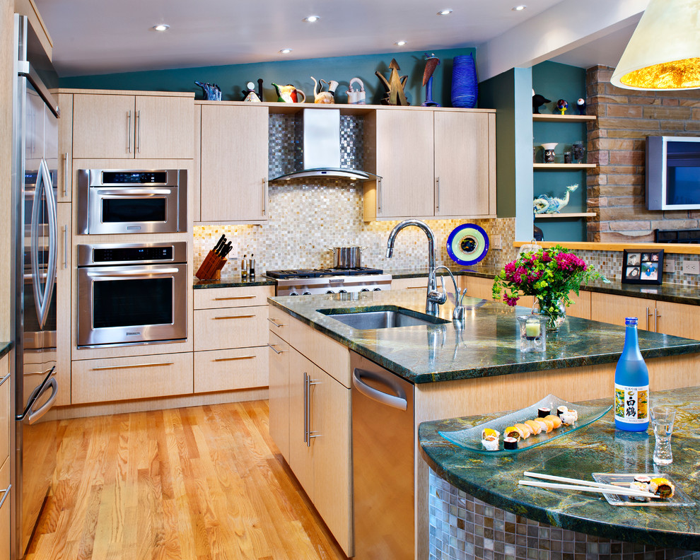 This is an example of a medium sized contemporary kitchen in New York with a submerged sink, flat-panel cabinets, light wood cabinets, granite worktops, multi-coloured splashback, stainless steel appliances, medium hardwood flooring and an island.