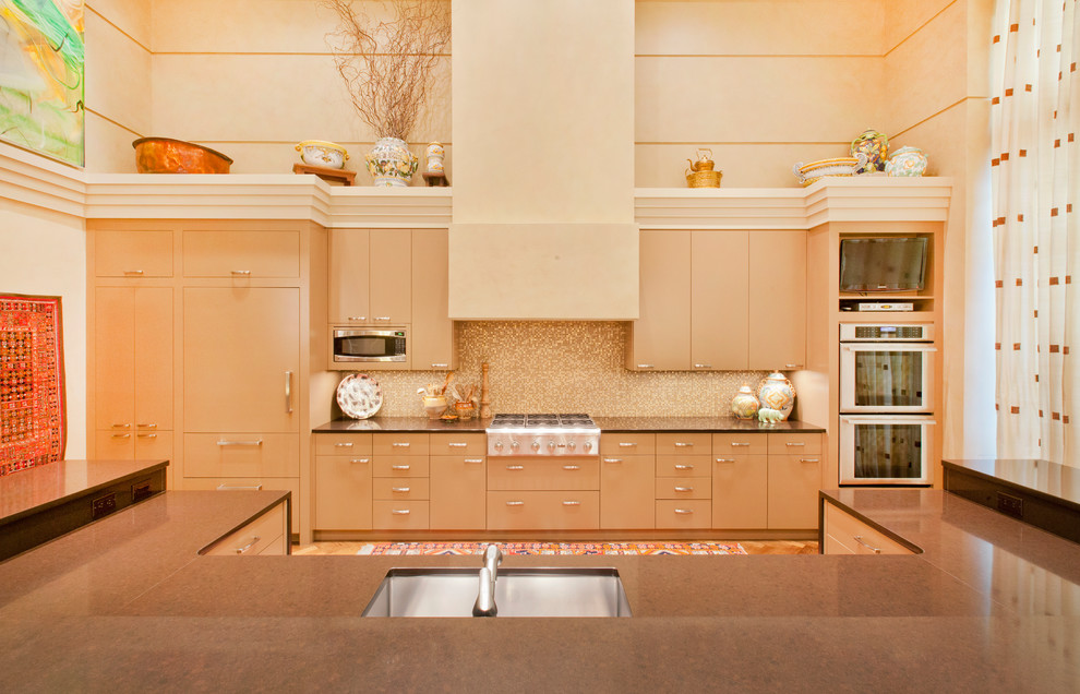 Inspiration for a contemporary galley open plan kitchen in Omaha with a submerged sink, flat-panel cabinets, beige cabinets, beige splashback, mosaic tiled splashback and integrated appliances.