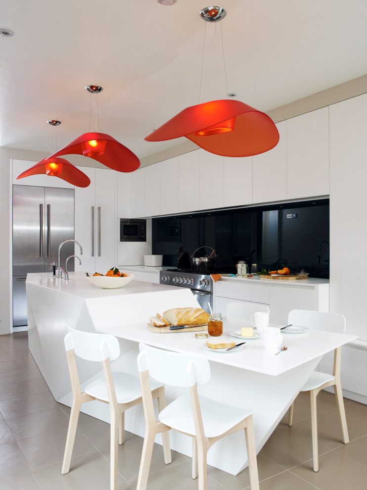 Moderne Küchenbar mit flächenbündigen Schrankfronten, Küchenrückwand in Schwarz, Glasrückwand, Küchengeräten aus Edelstahl und Kücheninsel in London